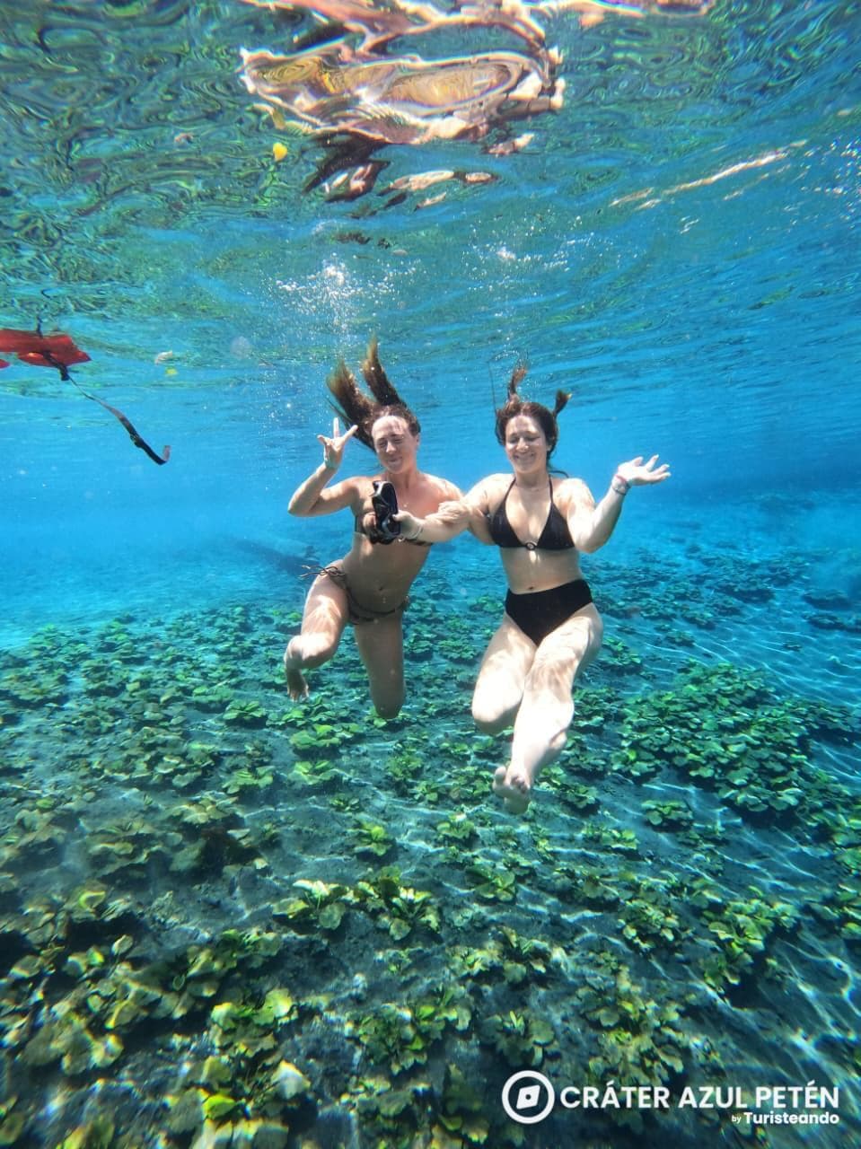 Swimmers in the turquoise, crystal-clear waters of Crater Azul